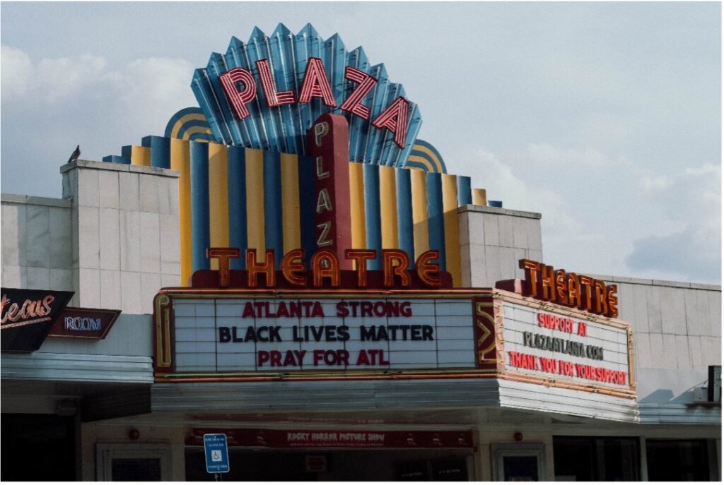A theater marquee reads: "Atlanta Strong" "Black Lives Matter" "Pray for All"